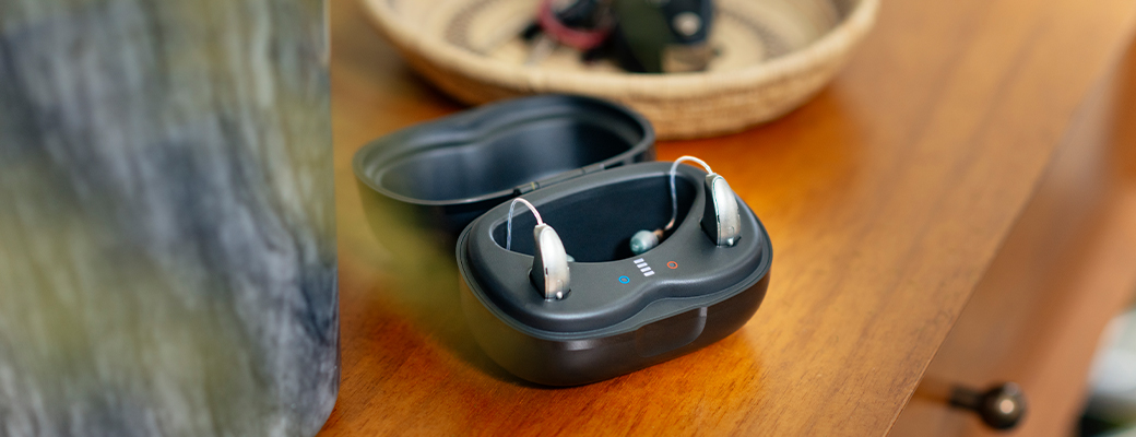 Image of behind the ear hearing aids in an open charger
